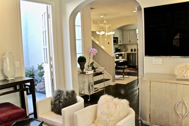 Living room - contemporary formal and open concept dark wood floor and brown floor living room idea in Orange County with white walls and a wall-mounted tv