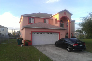 Photo of a medium sized classic two floor render house exterior in Orlando.