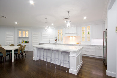 Inspiration for a large traditional l-shaped eat-in kitchen in Brisbane with an undermount sink, shaker cabinets, white cabinets, marble benchtops, white splashback, stainless steel appliances, dark hardwood floors and with island.