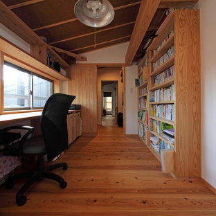 Design ideas for a modern home office and library in Tokyo Suburbs with white walls, medium hardwood flooring, a built-in desk and brown floors.