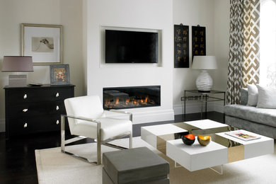 This is an example of a mid-sized contemporary living room in London with beige walls, dark hardwood floors, a ribbon fireplace, a plaster fireplace surround, a wall-mounted tv and black floor.