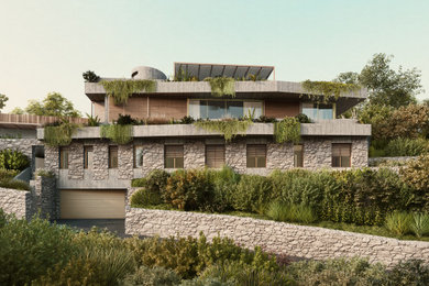 Idée de décoration pour une grande façade de maison design en pierre à trois étages et plus avec un toit plat et un toit mixte.