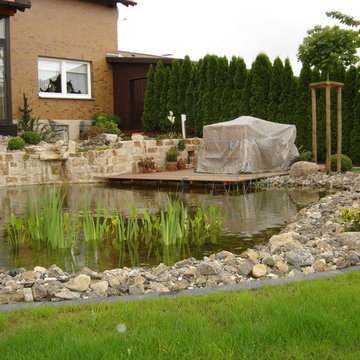 Gartenteichanlage mit Wasserfall und Stegterrasse