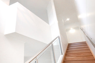 Mid-sized modern wood straight staircase in Sydney with wood risers.