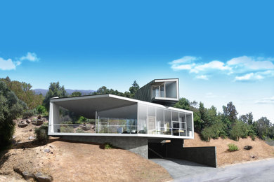 Imagen de fachada de casa gris contemporánea pequeña de dos plantas con revestimiento de metal, tejado a la holandesa y tejado de metal