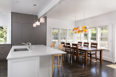 Mid-sized elegant l-shaped dark wood floor eat-in kitchen photo in Seattle with an undermount sink, shaker cabinets, gray cabinets, quartz countertops, white backsplash, glass tile backsplash, paneled appliances and an island