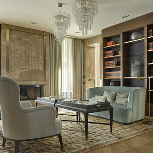 This is an example of a transitional home office in Saint Petersburg with a library, light hardwood floors and a ribbon fireplace.