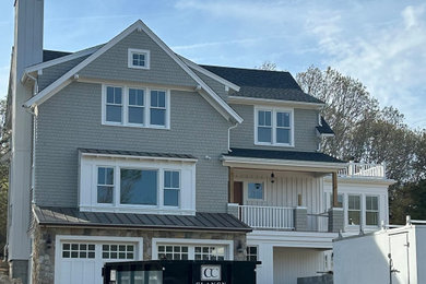Craftsman gray three-story shingle house exterior idea in Boston with a shingle roof and a black roof