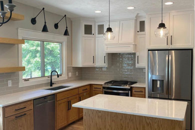 Example of a mid-sized arts and crafts l-shaped eat-in kitchen design in Omaha with shaker cabinets, medium tone wood cabinets, quartzite countertops and an island