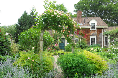 Photo of a mid-sized rustic full sun front yard gravel garden path in Providence.