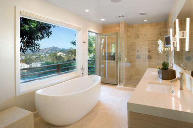 Inspiration for a contemporary bathroom in Los Angeles with an undermount sink, a freestanding tub, a corner shower and beige tile.