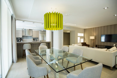 Great room - mid-sized transitional light wood floor and gray floor great room idea in Miami with beige walls and no fireplace