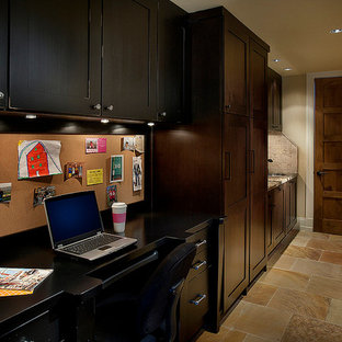 This is an example of a mid-sized traditional study room in Phoenix with a built-in desk, beige walls, travertine floors and no fireplace.