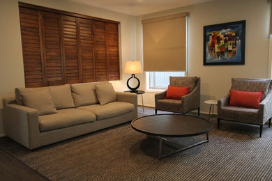 Diseño de salón abierto contemporáneo de tamaño medio sin chimenea con paredes beige y suelo de madera oscura