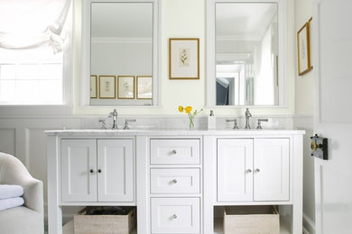 Photo of a transitional bathroom in New York with shaker cabinets, white cabinets, yellow walls, an undermount sink, white floor and white benchtops.