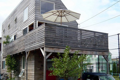 Photo of a beach style two-storey exterior in Other with wood siding.