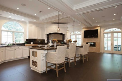 Open concept kitchen - large contemporary u-shaped open concept kitchen idea in New York with white cabinets, recessed-panel cabinets, stainless steel appliances and an island