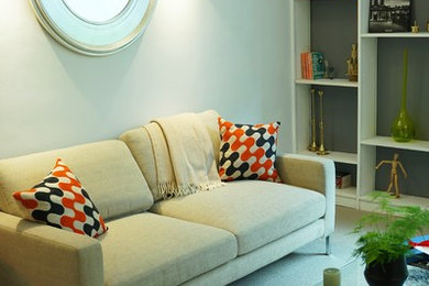 This is an example of a medium sized contemporary open plan living room in London with grey walls, carpet and grey floors.