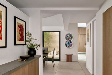 Entryway - modern porcelain tile, gray floor and vaulted ceiling entryway idea in Philadelphia with white walls