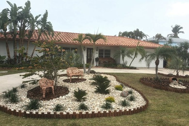 This is an example of a large mediterranean drought-tolerant and full sun front yard landscaping in Miami.