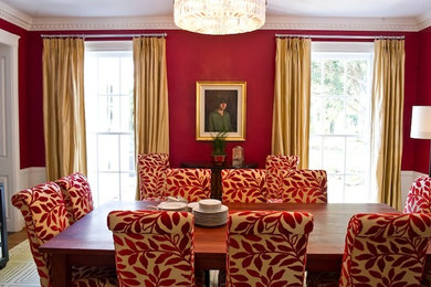 Inspiration for a timeless enclosed dining room remodel in Charlotte with red walls