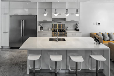 Design ideas for a modern eat-in kitchen in Toronto with stainless steel appliances, concrete floors, with island and grey floor.