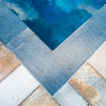The mark of fine craftsmanship; the continuous corner of stone pool coping.