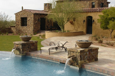 Mid-sized tuscan brown two-story mixed siding gable roof photo in Phoenix