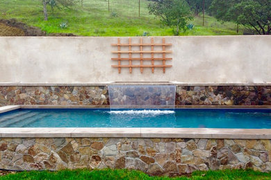 Pool fountain - mid-sized mediterranean backyard stone and rectangular lap pool fountain idea in San Francisco