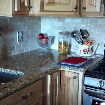 Natural Hickory Cabinets w/Santa Cecilia Granite and Crema Marfil Subway Tile