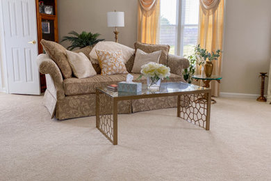 Inspiration for a large timeless enclosed carpeted and beige floor living room remodel in Other with beige walls and a corner tv