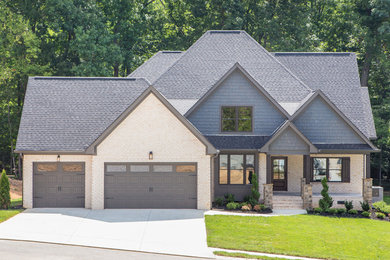 Inspiration for a large timeless multicolored two-story brick gable roof remodel in Other