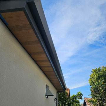 Wood Grained Metal Soffits with Angle Face Rain Gutters and Smooth Downspouts