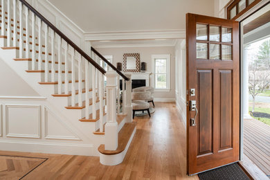 Photo of a large traditional front door in Boston with beige walls, medium hardwood floors, a single front door and a medium wood front door.