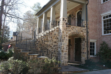 Example of a large classic three-story brick exterior home design in Atlanta
