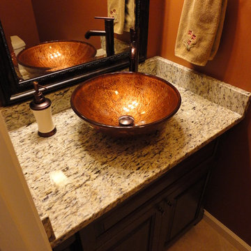 Powder room with golden vessel sink