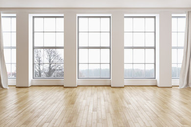 Large minimalist light wood floor and beige floor living room photo in Chicago with white walls