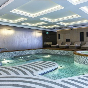 Contemporary indoor pool and spa with recycled glass mosaic