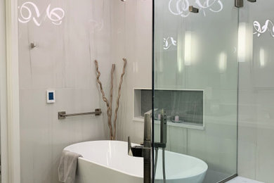 Large trendy master white tile and porcelain tile porcelain tile, gray floor and double-sink bathroom photo in Chicago with flat-panel cabinets, black cabinets, an undermount sink, quartz countertops, a hinged shower door, white countertops and a built-in vanity