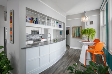 Transitional galley gray floor kitchen photo in Omaha with open cabinets, gray backsplash, an island and gray countertops