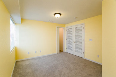 Inspiration for a mid-sized timeless guest carpeted bedroom remodel in Denver with yellow walls
