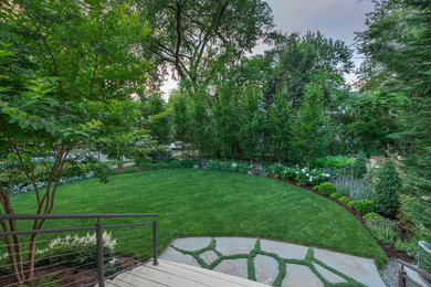 Design ideas for a mid-sized traditional backyard full sun formal garden for summer in DC Metro with natural stone pavers.