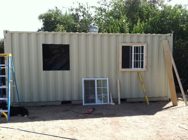 The couple bought windows at Home Depot, cut holes for them and added 