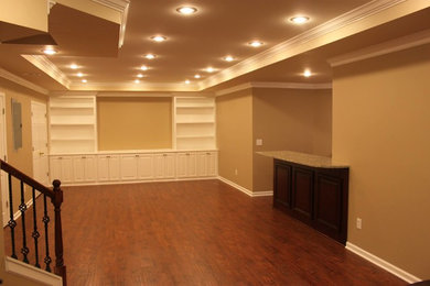 Example of a large underground medium tone wood floor basement design in Atlanta with beige walls