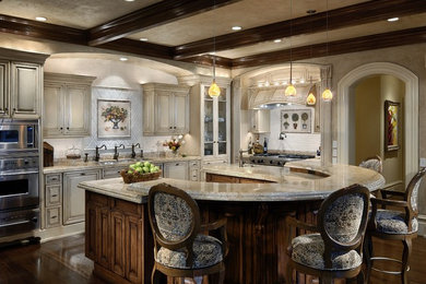 Eat-in kitchen - large shabby-chic style eat-in kitchen idea in Charlotte with an undermount sink, raised-panel cabinets, granite countertops, stainless steel appliances and an island