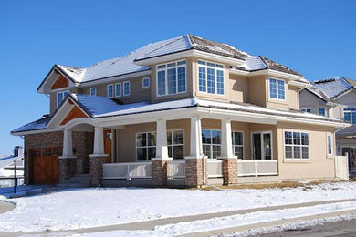 Example of a large arts and crafts beige two-story concrete exterior home design in Denver