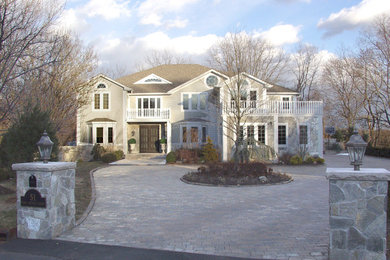 Mid-sized elegant beige two-story wood exterior home photo in New York with a shingle roof