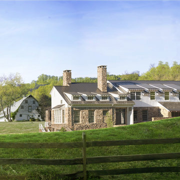 American Farmhouse with Board and Batten and Rustic Stone Barn Beyond