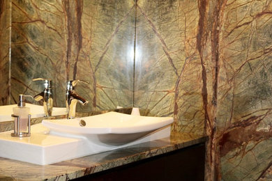 Inspiration for a small rustic 3/4 beige tile bathroom remodel in DC Metro with dark wood cabinets, a vessel sink and granite countertops