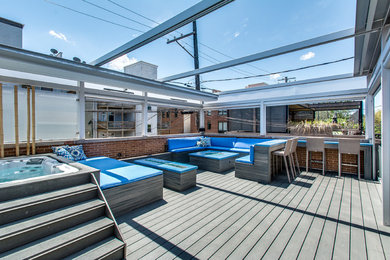 Design ideas for an expansive modern rooftop deck in Chicago with a pergola and a fire feature.